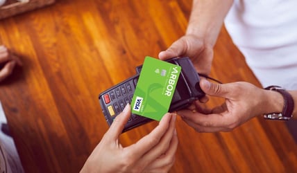 Member using Arbor's tap to pay debit card at store