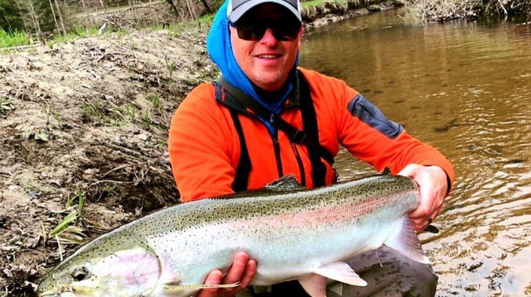 John with fish in stream